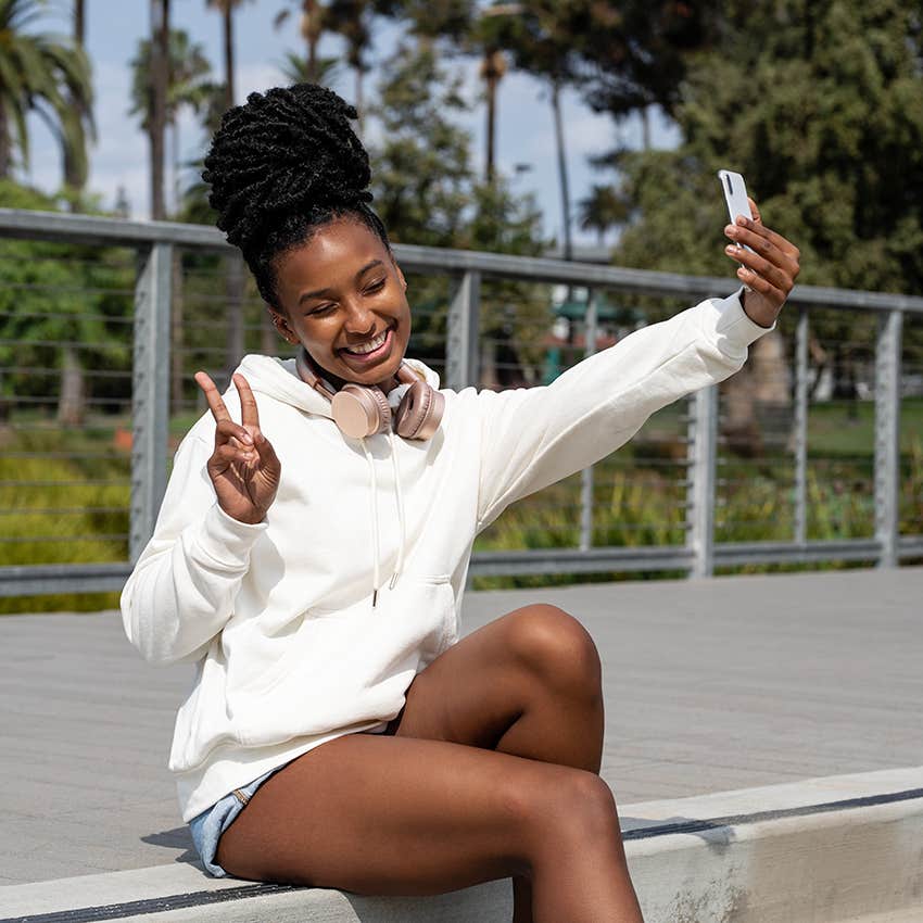 independent woman posing for a selfie to post online