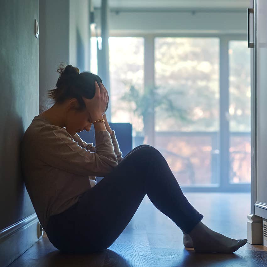 sad woman sitting alone feeling like a burden
