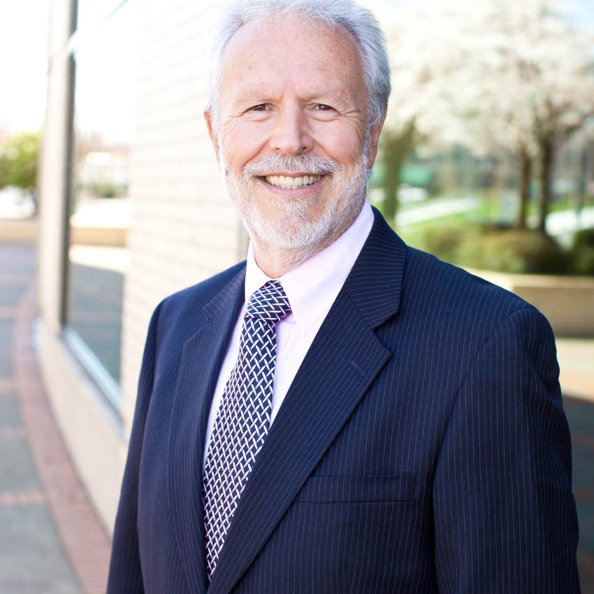 Smiling man in a suit at work