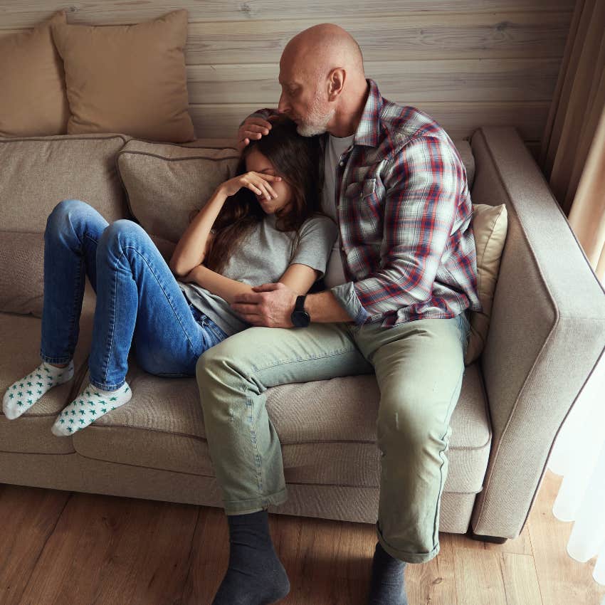 dad comforting tween daughter with a hug while teaching her that big feelings don't have to control her