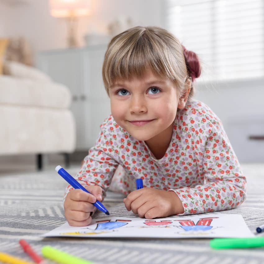little girl enjoying her drawing hobby without consequences 