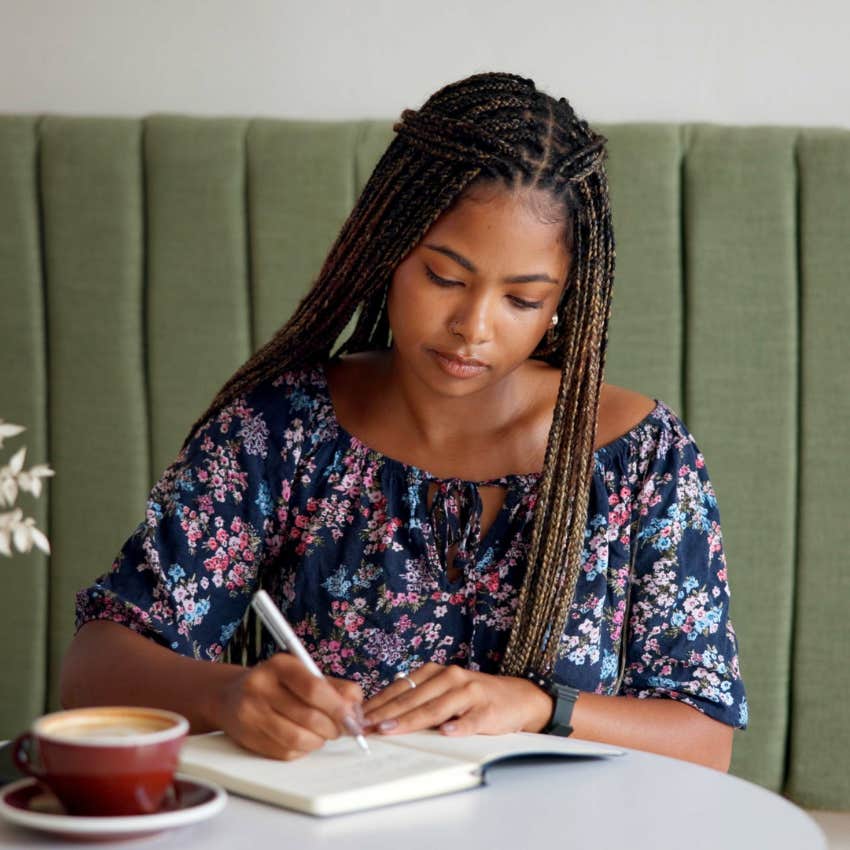 intelligent woman spending alone time by herself writing
