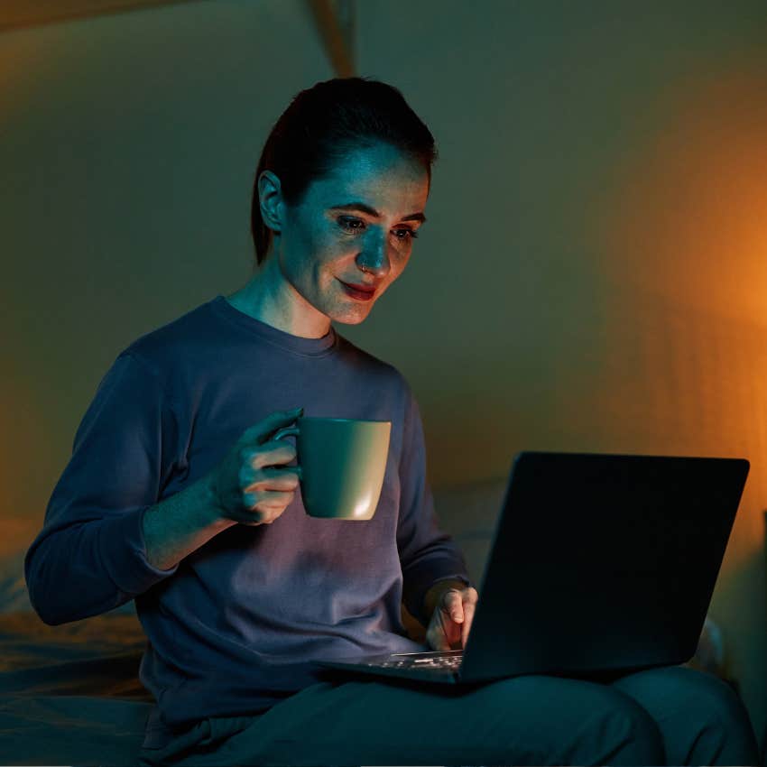 highly intelligent woman on her laptop watching a documentary