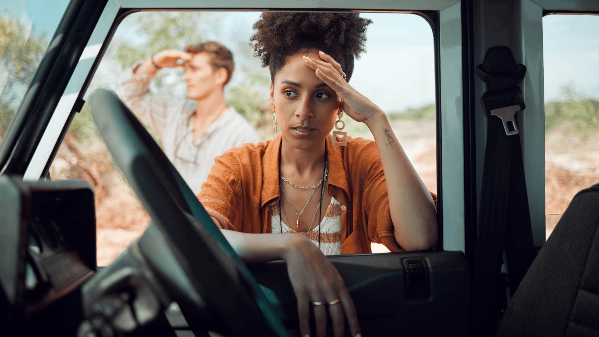woman looking stressed at car as she needs to get around without a gps