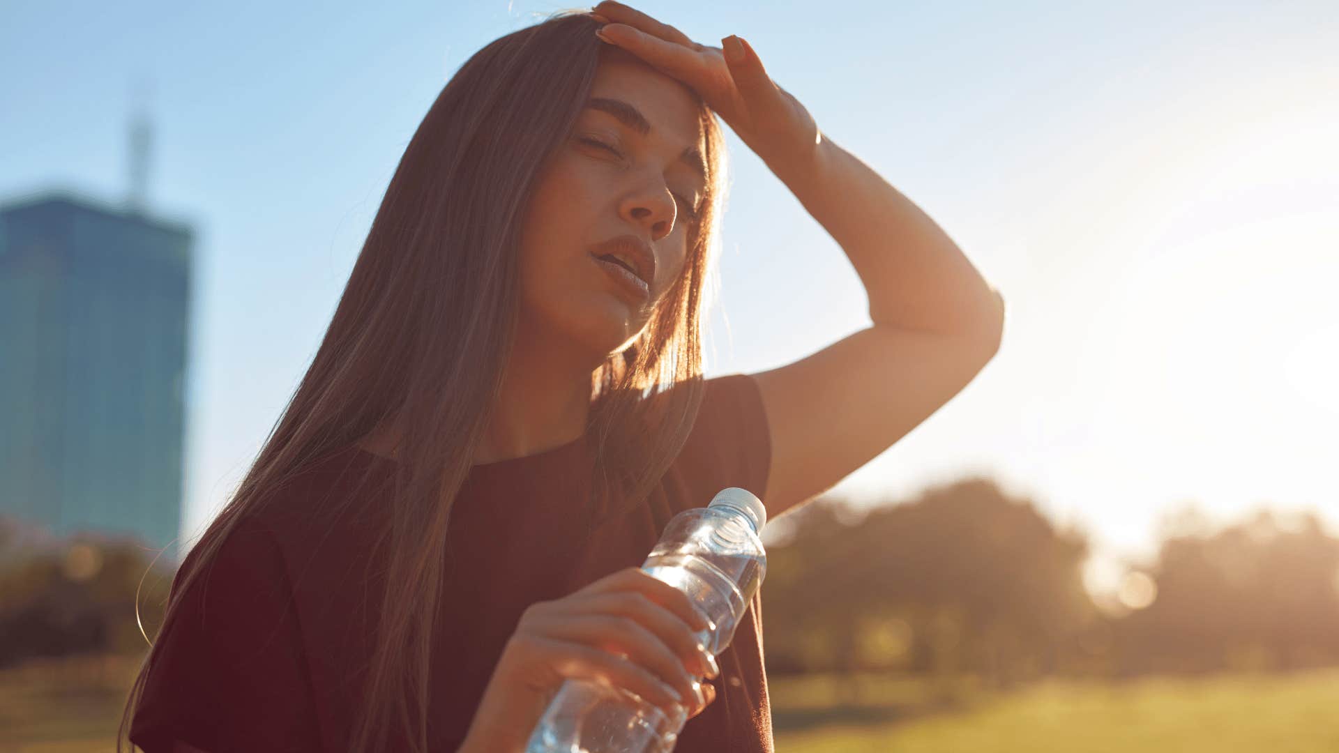 woman wiping sweat from forehead as she goes hours without air conditioning 