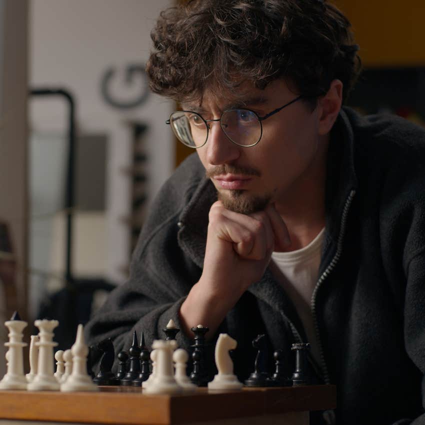 highly intelligent man playing chess for fun hobby complicated puzzles