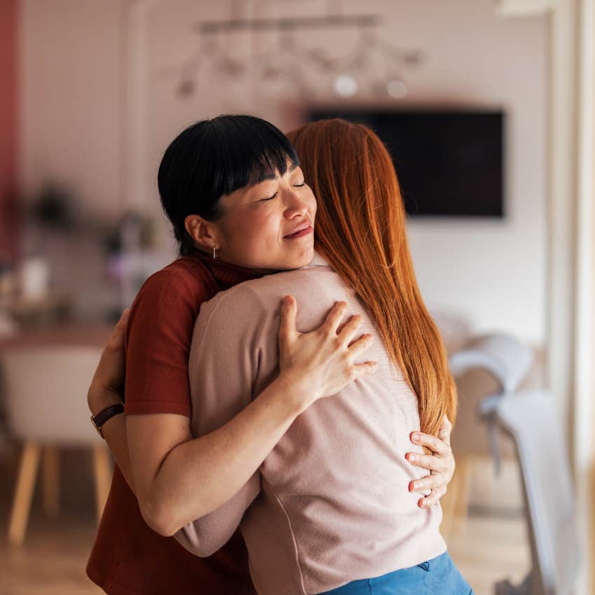 sensitive and intuitive woman feeling joy hugging friend who needs support
