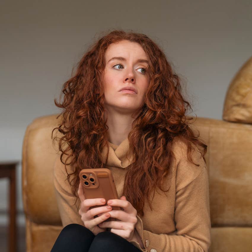 Emotionally draining woman looking bored with her phone 