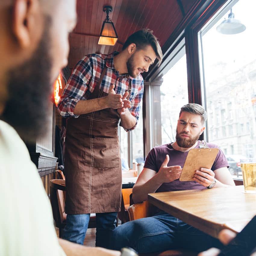 Man in a restaurant complaining to the waiter 