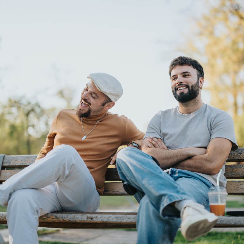 two old-school men chatting on park bench without a phone in sight