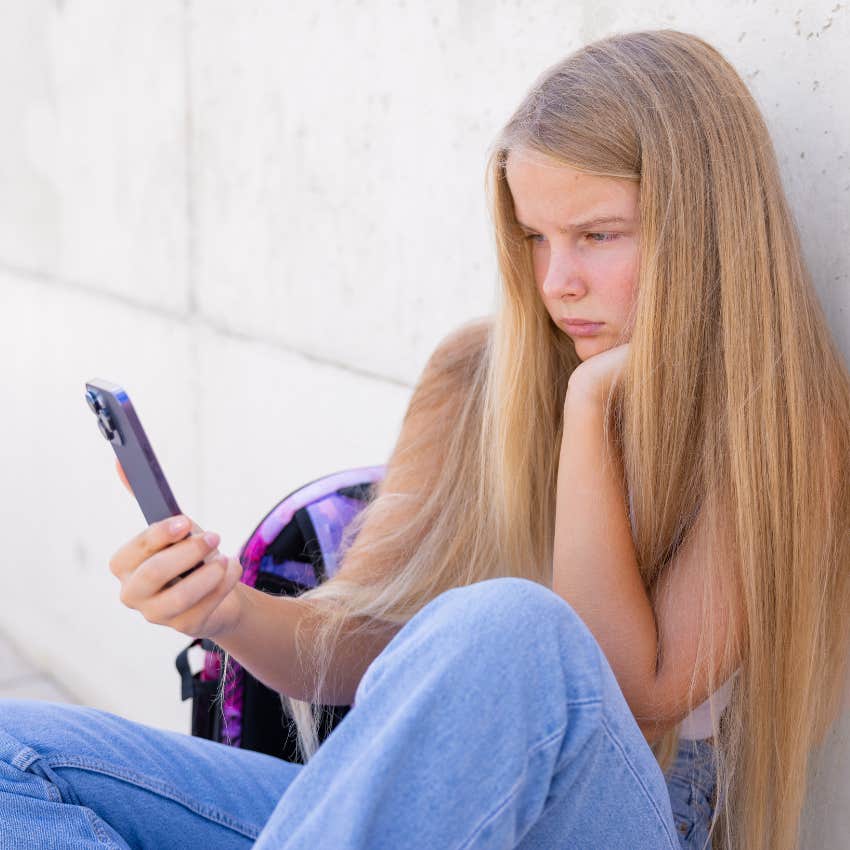 little girl who can't go places without a phone