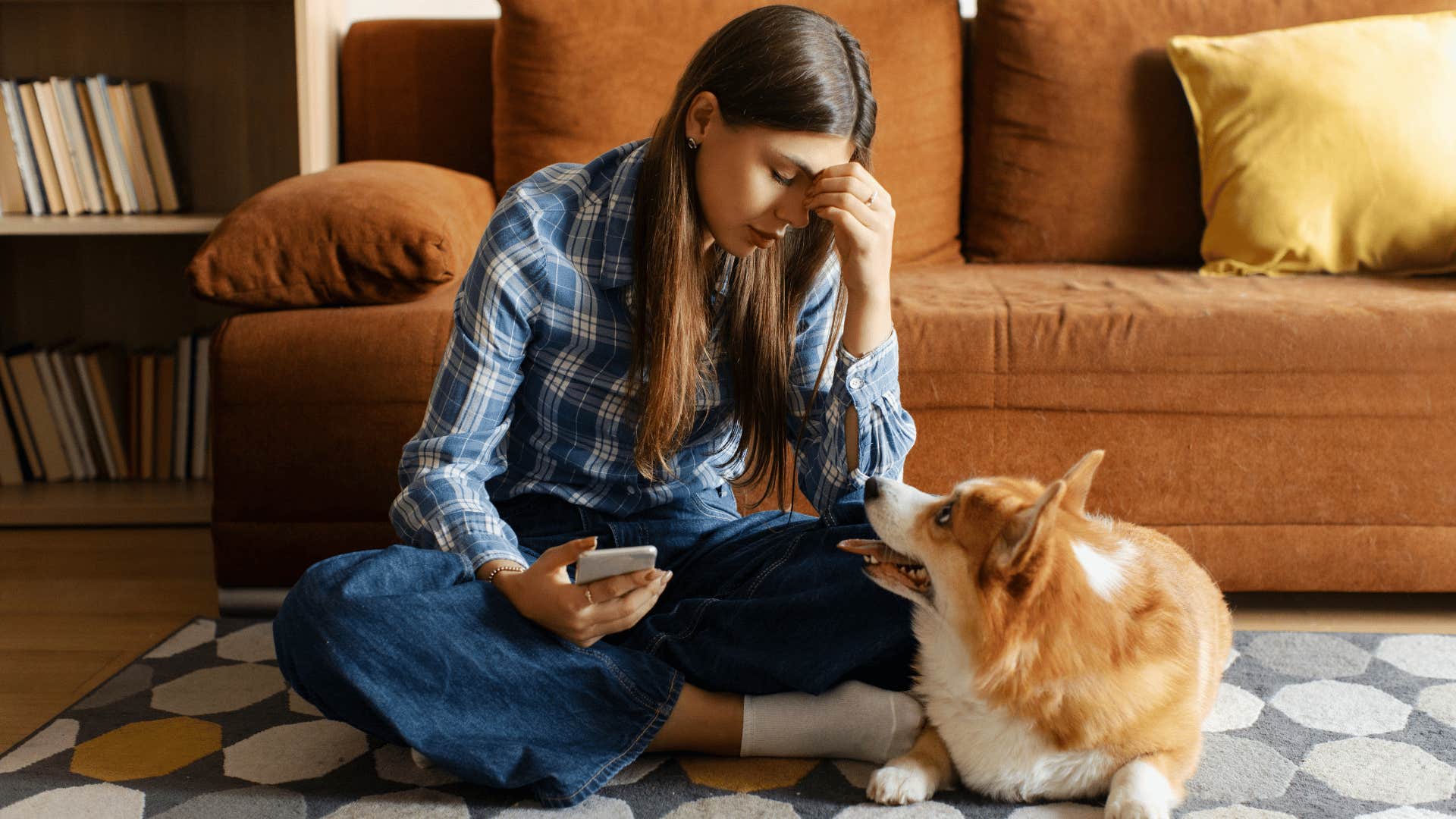 upset woman talking to her dog to vent during the work day