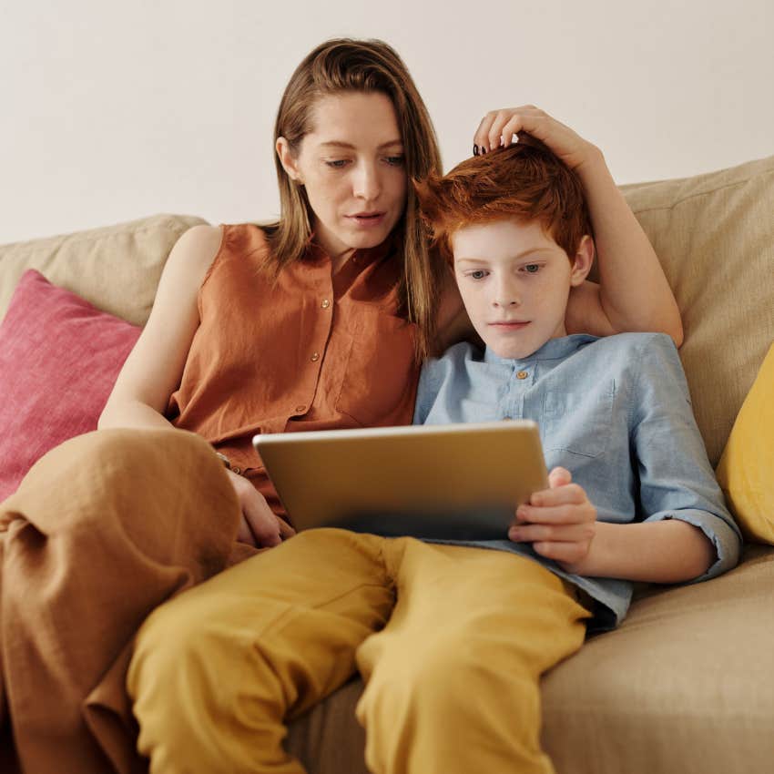 mom sitting with young son using an ipad