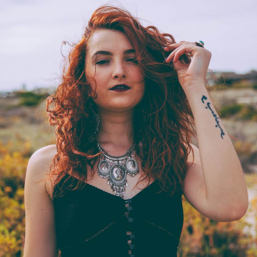 free-spirited woman going with the flow standing outside