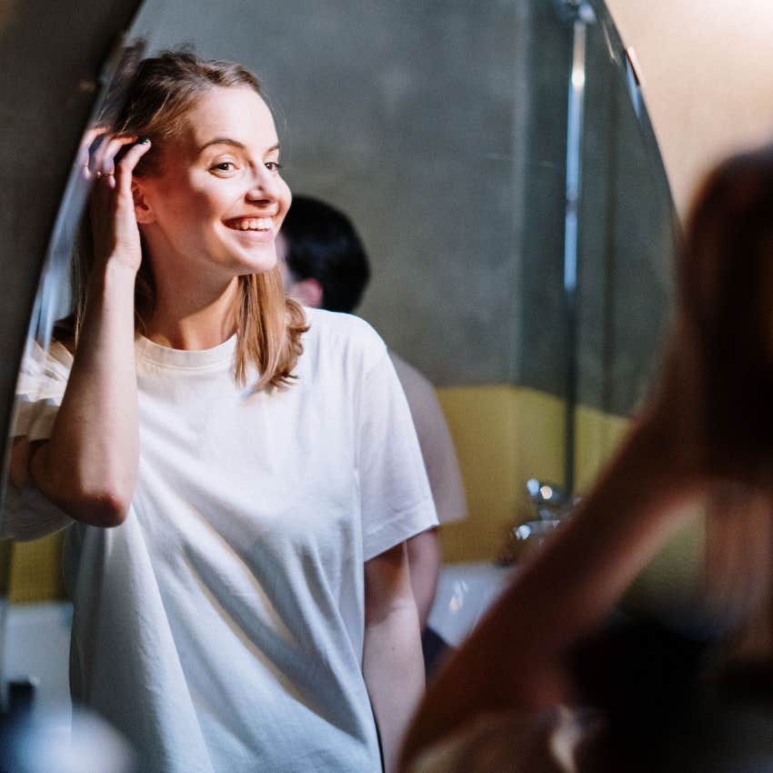 happy woman loving herself again looking in mirror