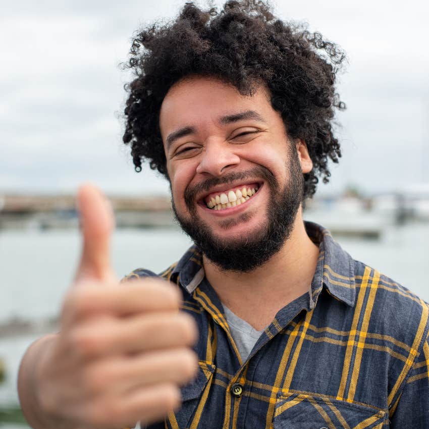 optimistic man doing a thumbs up and looking happy