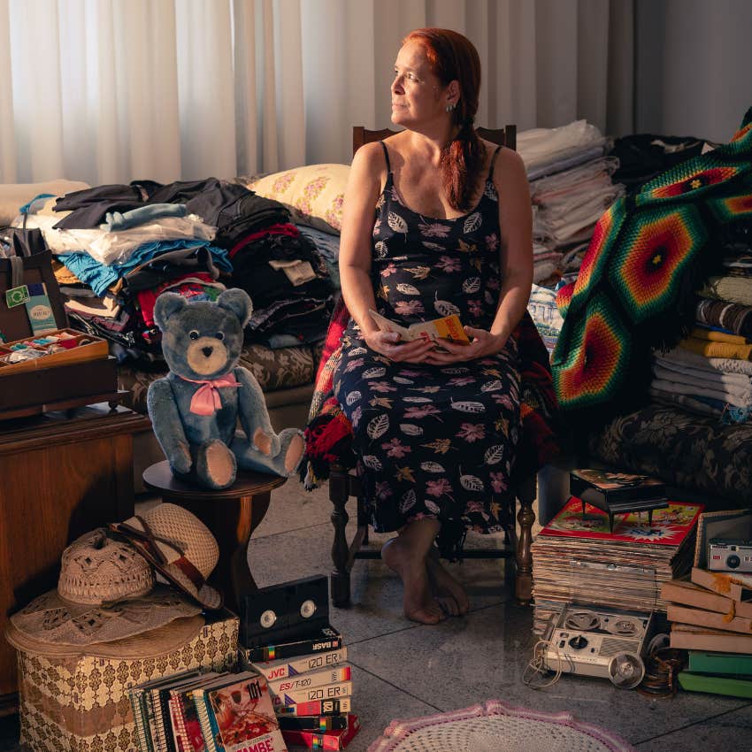 middle aged woman surrounded by heirlooms from the past