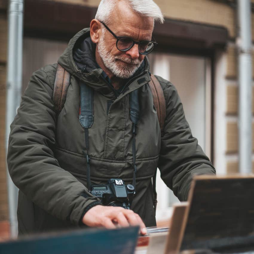 mature man looking through records at record store reliving childhood