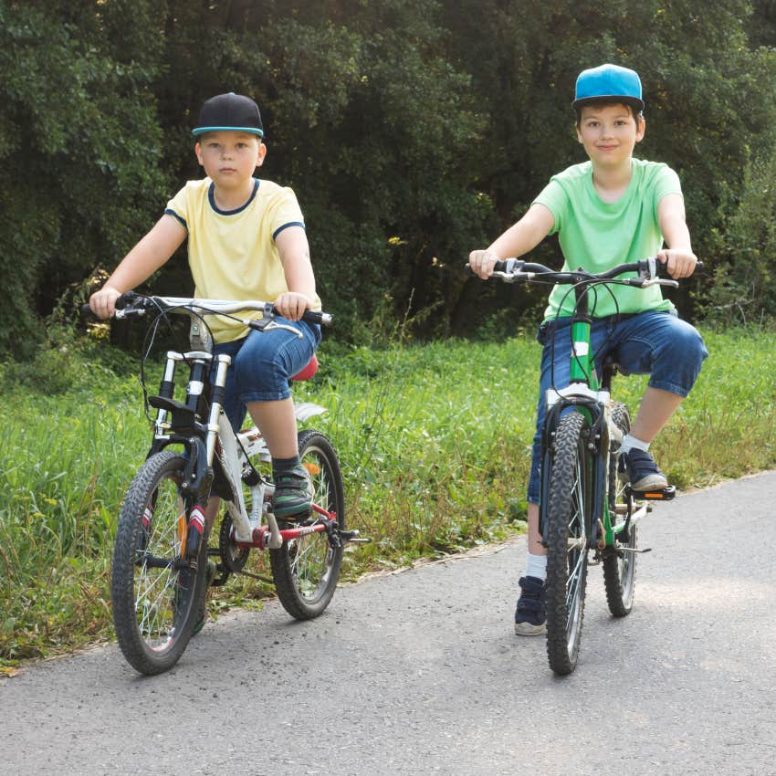 two boys riding bikes playing outside like kids did in the 70s and 80s