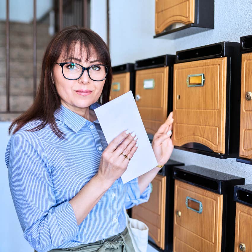 gen X woman who can address a letter standing in the post office