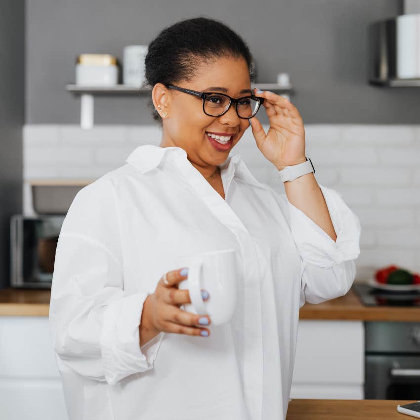 content happy woman drinking coffee not in a rush to start her day