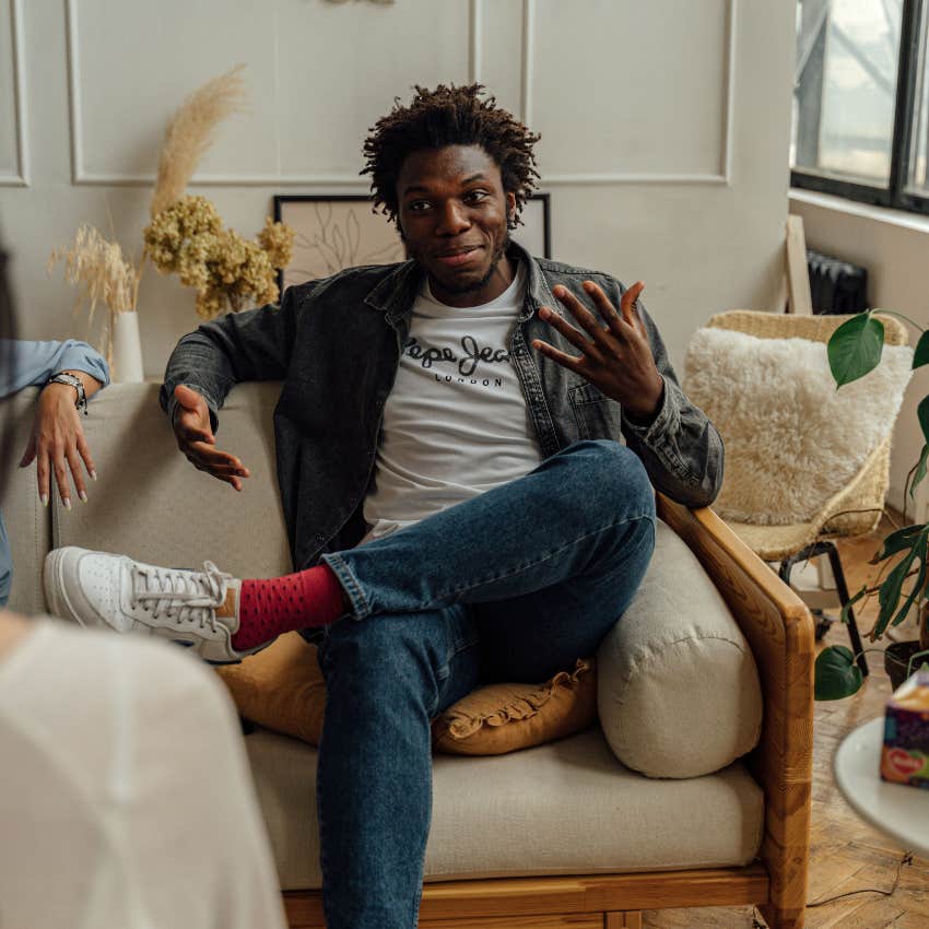 happy and content man talking to friends saying he prefers this
