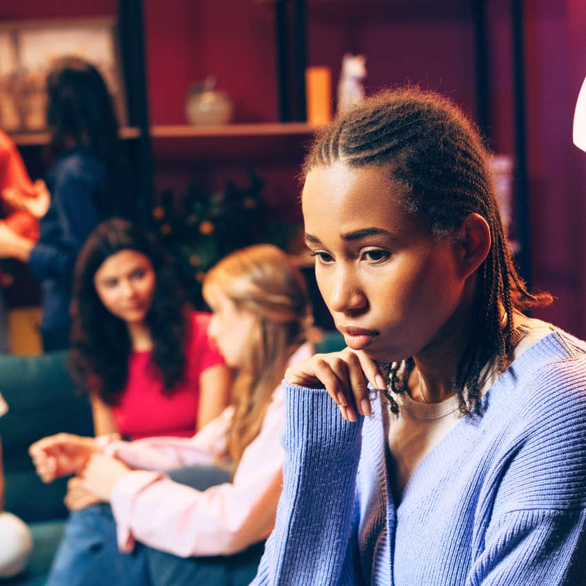 Smart woman looking stressed in a crowded party.