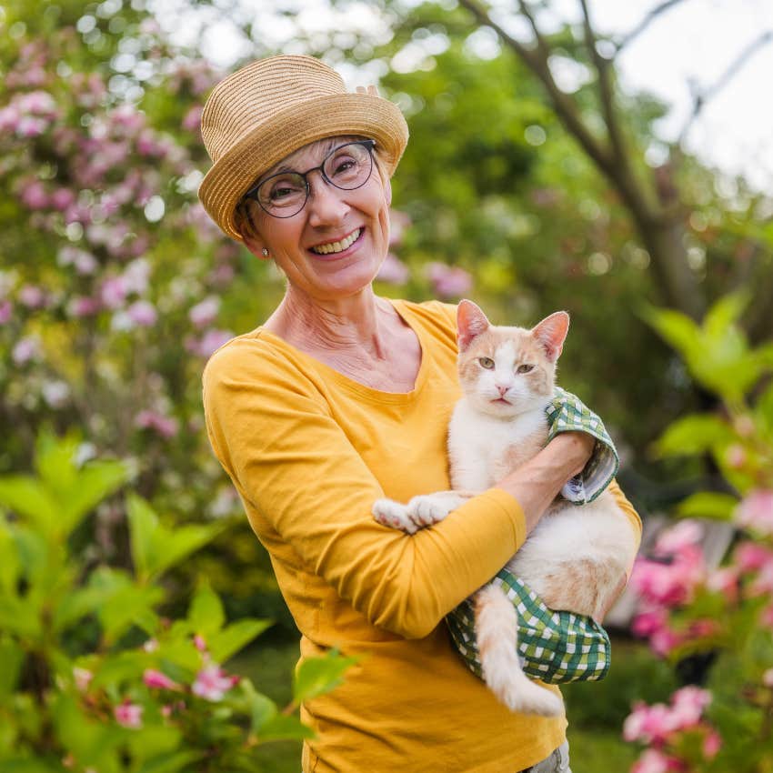 happy woman holding her cat who doesn't care what other people think