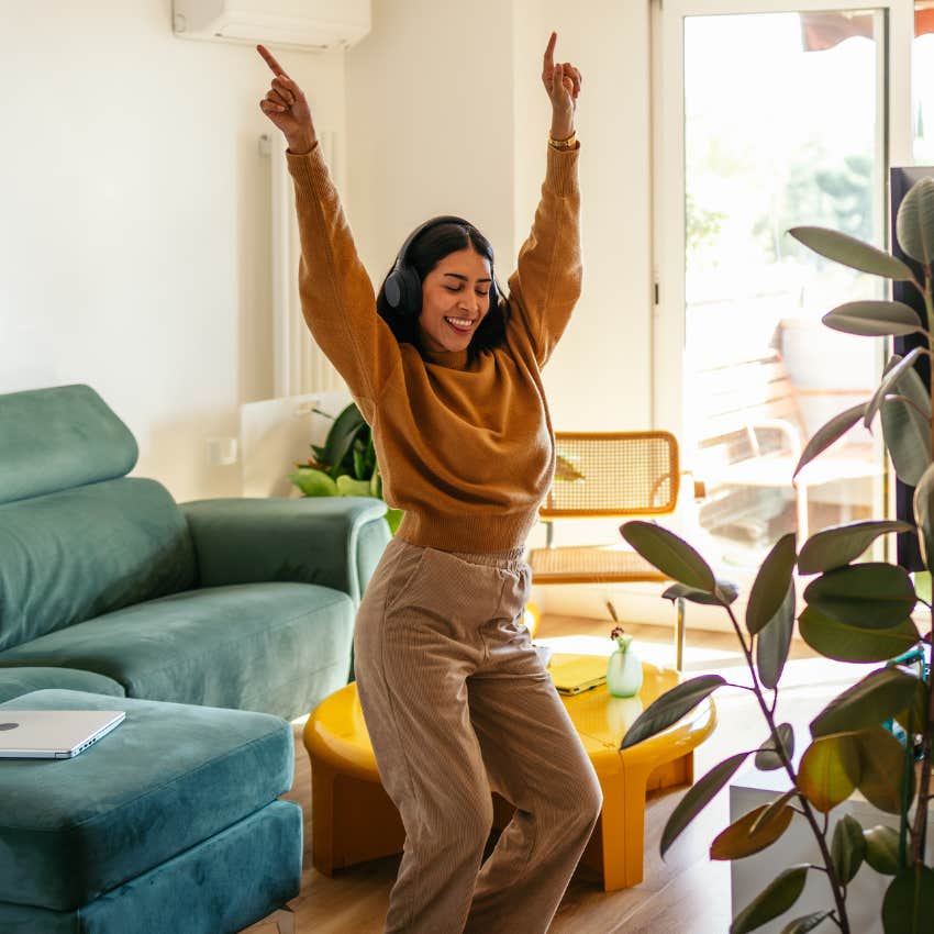 Woman dancing in her living room living unapologetically without asking for permission