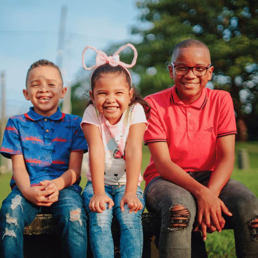 three siblings smiling together