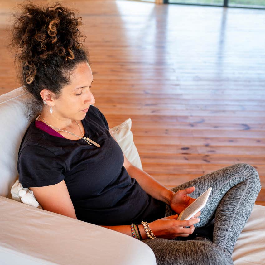 woman happy staying home with kindle enjoying the comfort of quiet