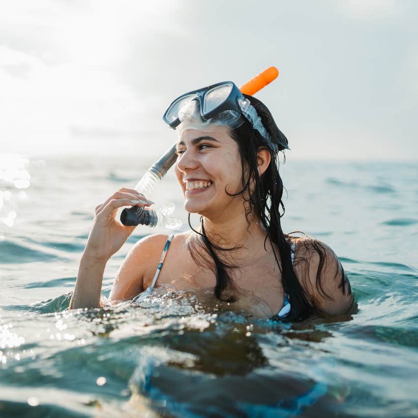 woman who would rather spend on travel swimming in snorkel 