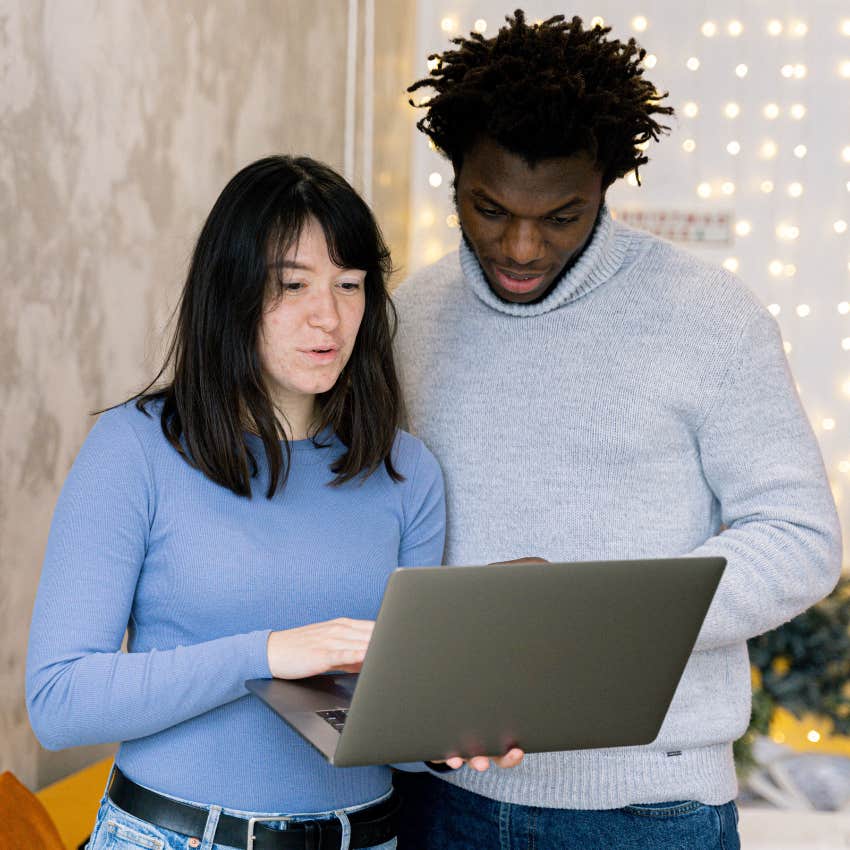woman asking partner who plays video games for tech help on computer