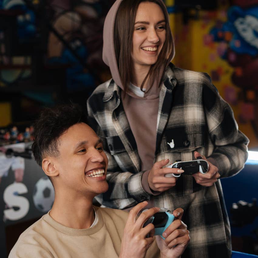 happy intelligent couple playing video games together