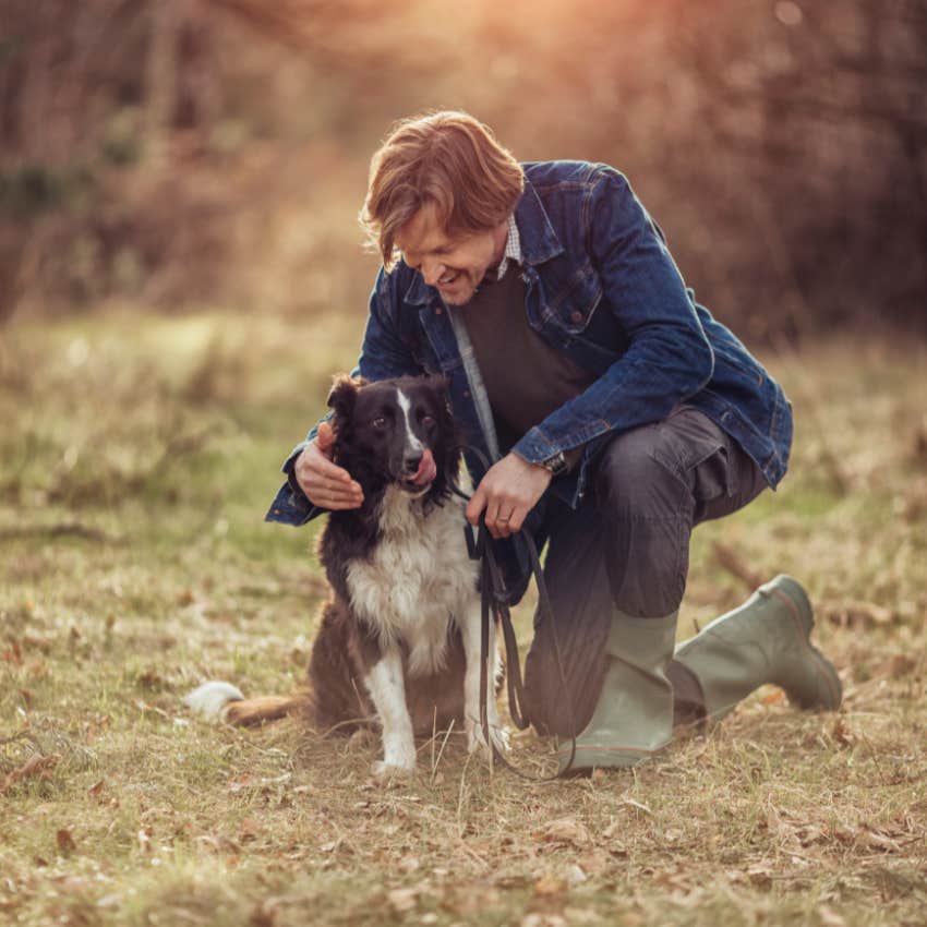 happy man over 40 petting his dog has stopped worrying about happiness