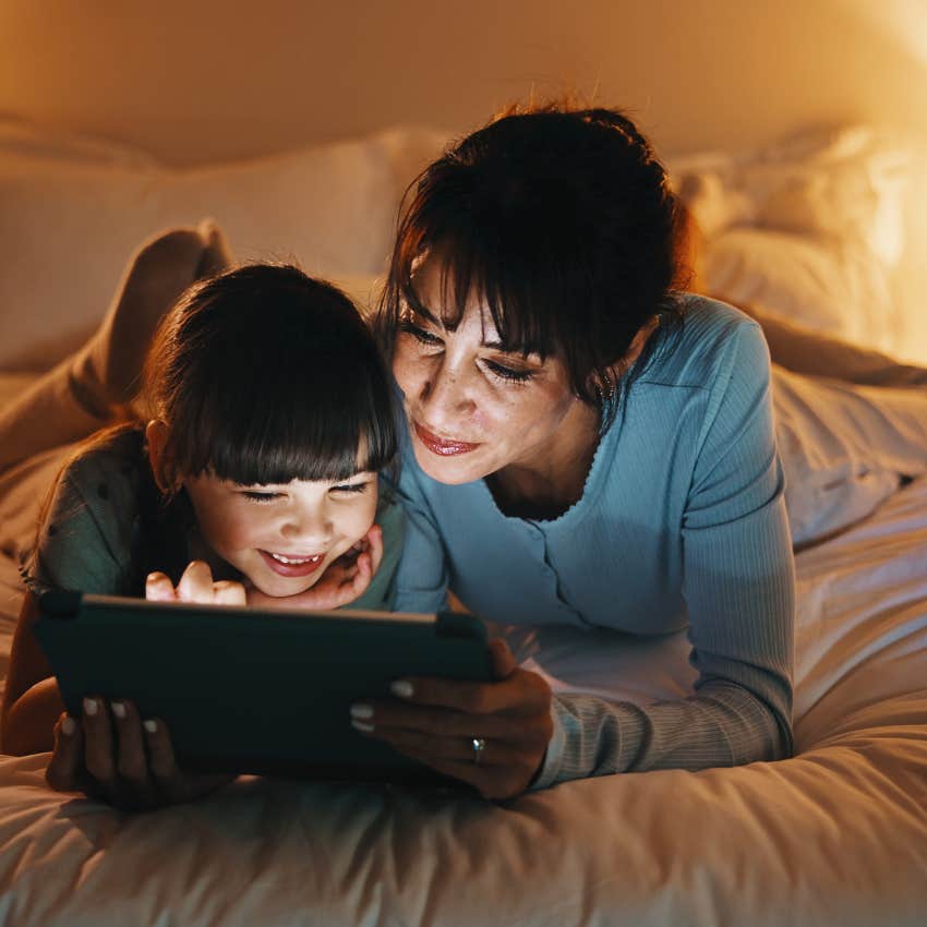 mom watching screen with daughter teaching moderation with screen time