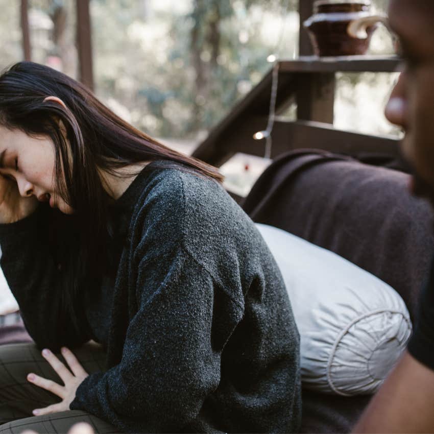 emotionally exhausted wife crying quietly with her partner
