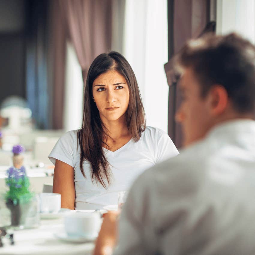 woman judging man across table