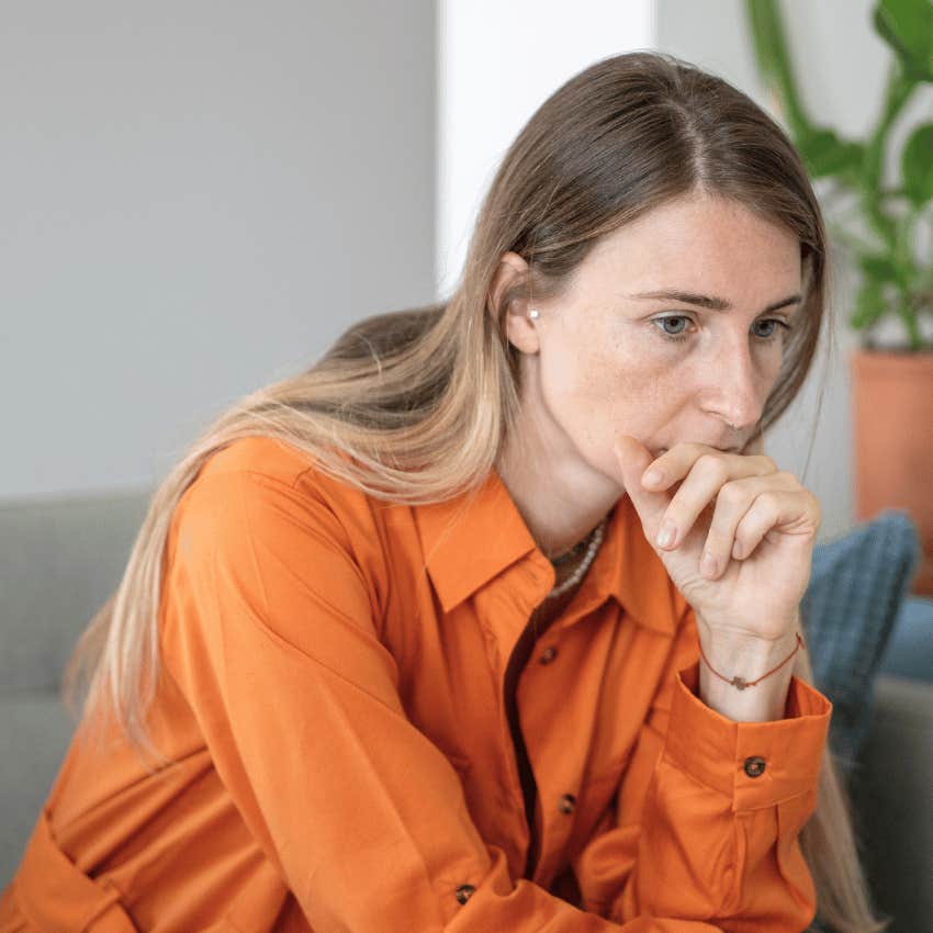 woman sitting with an anxious expression