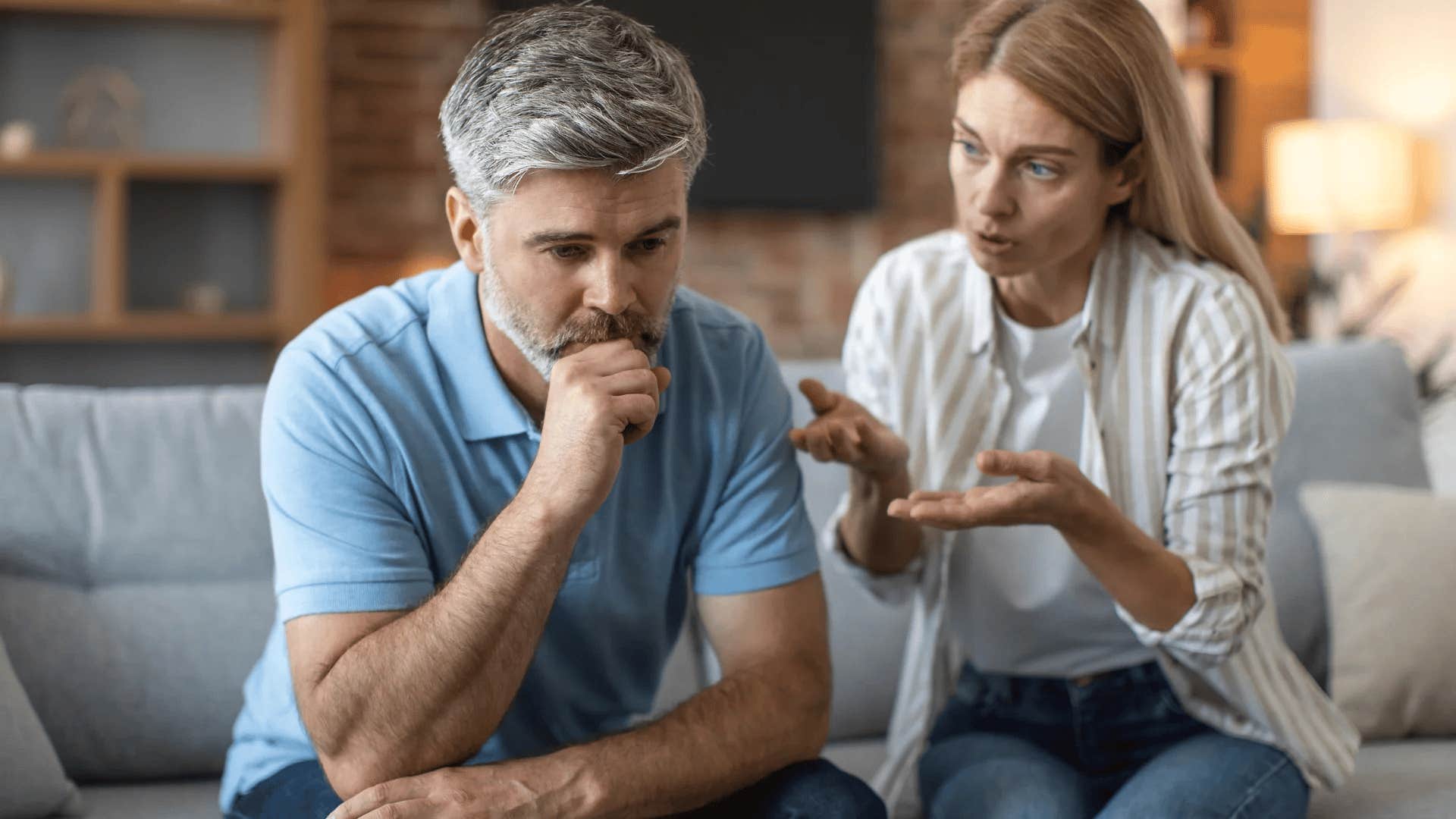wife criticizing her upset husband at home