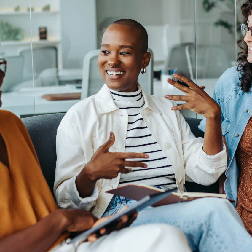 confident woman talking to a group of people saying remind me again