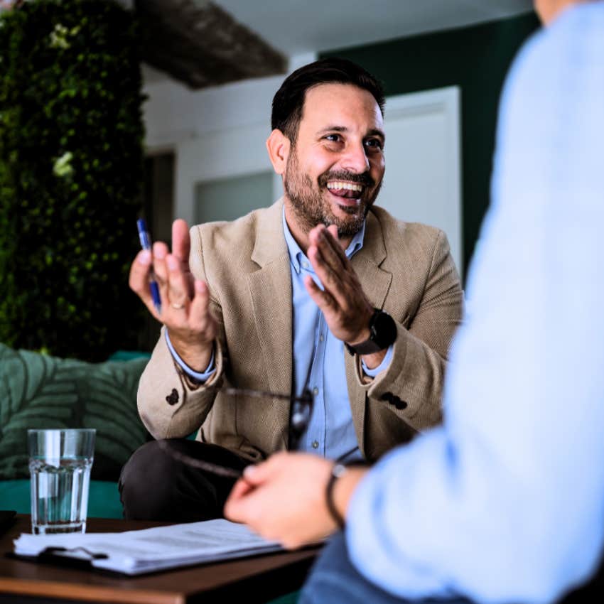 anxious man saying isn't that funny to his co-worker during a meeting