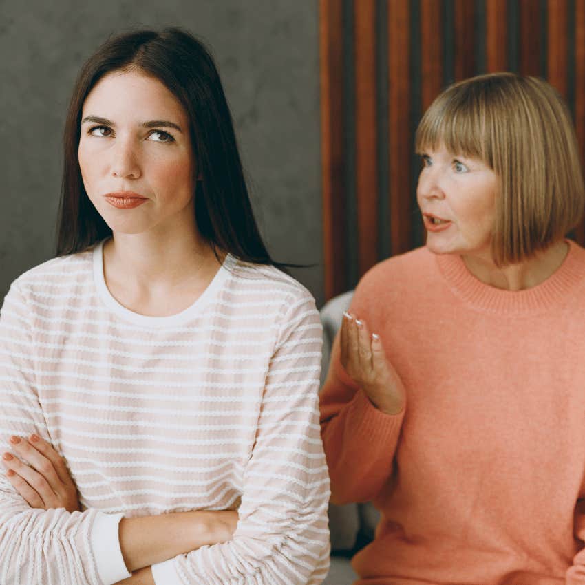 young woman rolling her eyes at older woman talking