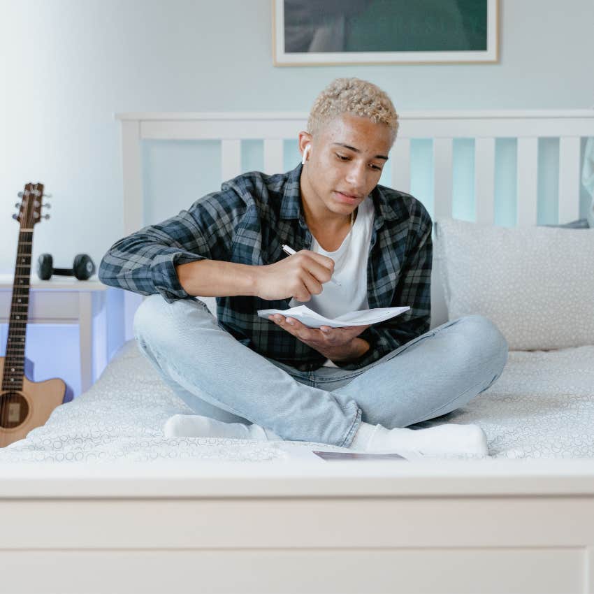 Teenager sitting at home looking for something to do without using a smartphone or other digital entertainment