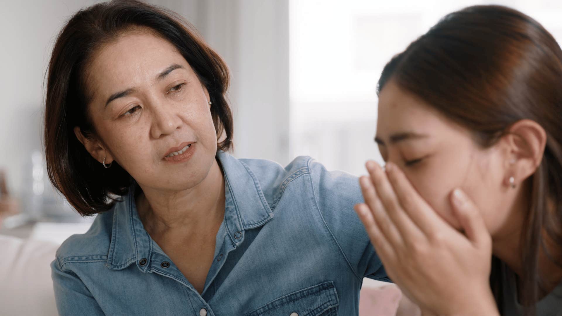 woman in denim shirt telling upset daughter you don't need to explain yourself