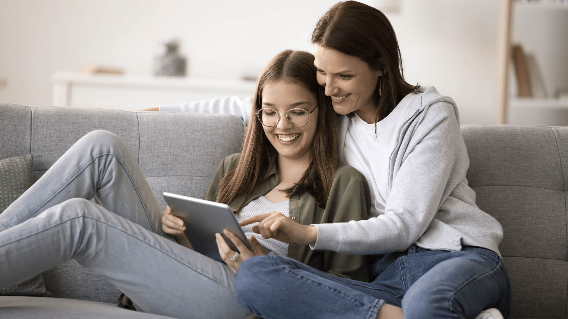 mother on the tablet with daughter telling her you don't need to worry about how much that costs