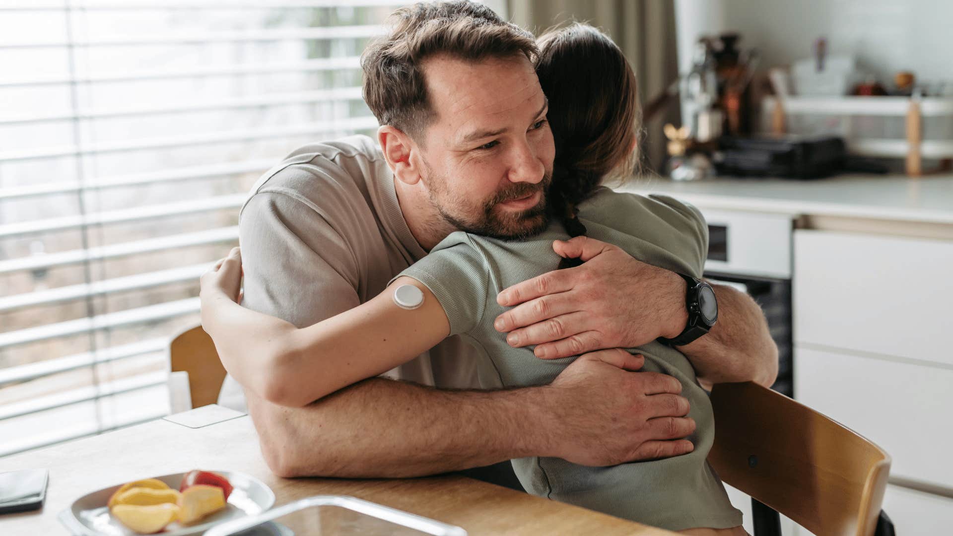 father hugging daughter as he tells her you shouldn't have to figure that out on your own