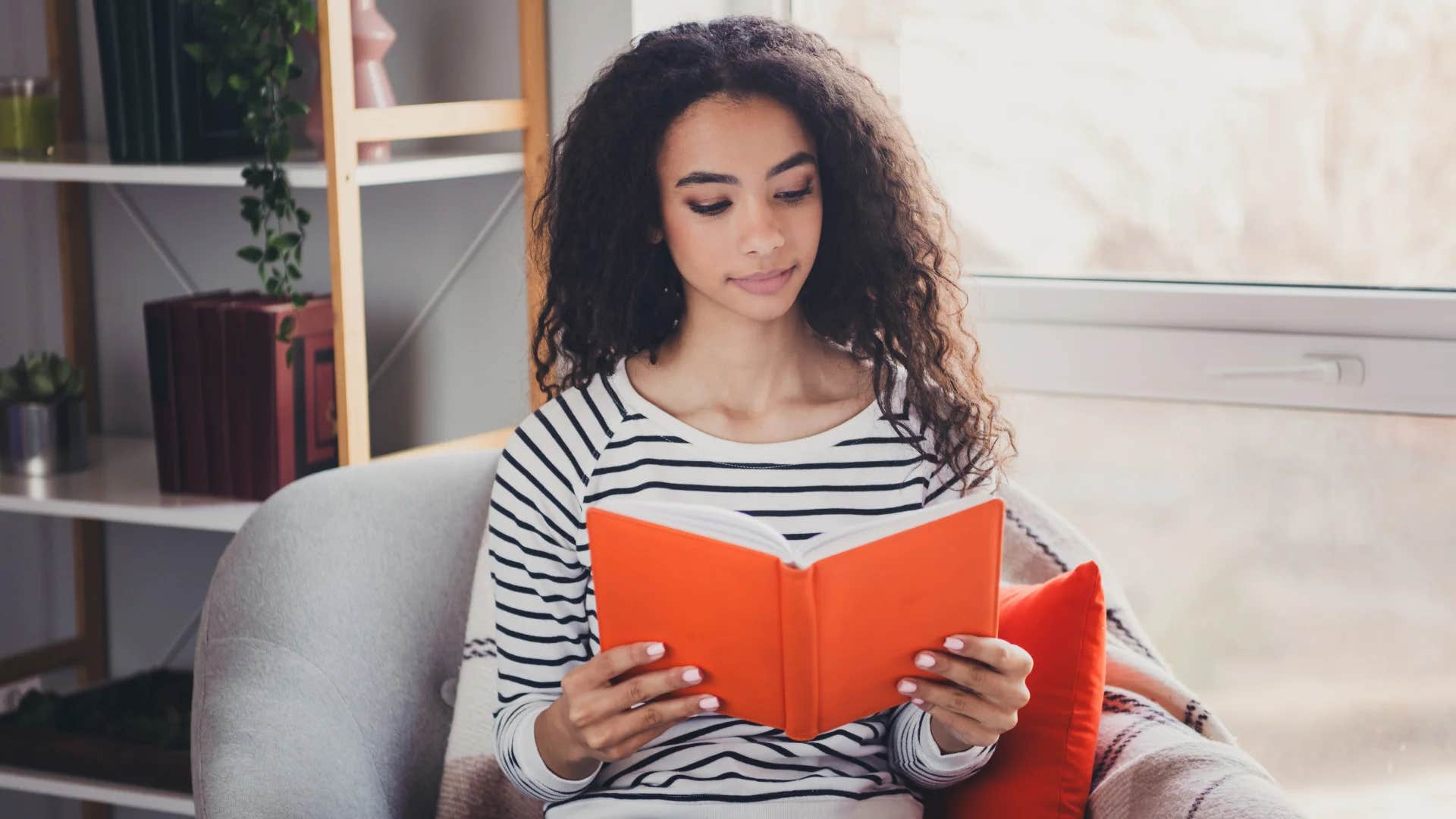 relaxed woman reading a book at home