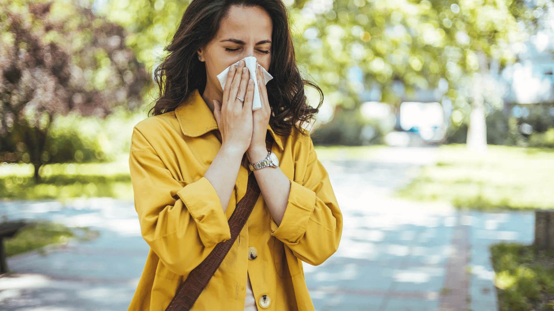 woman walking alone blowing her nose