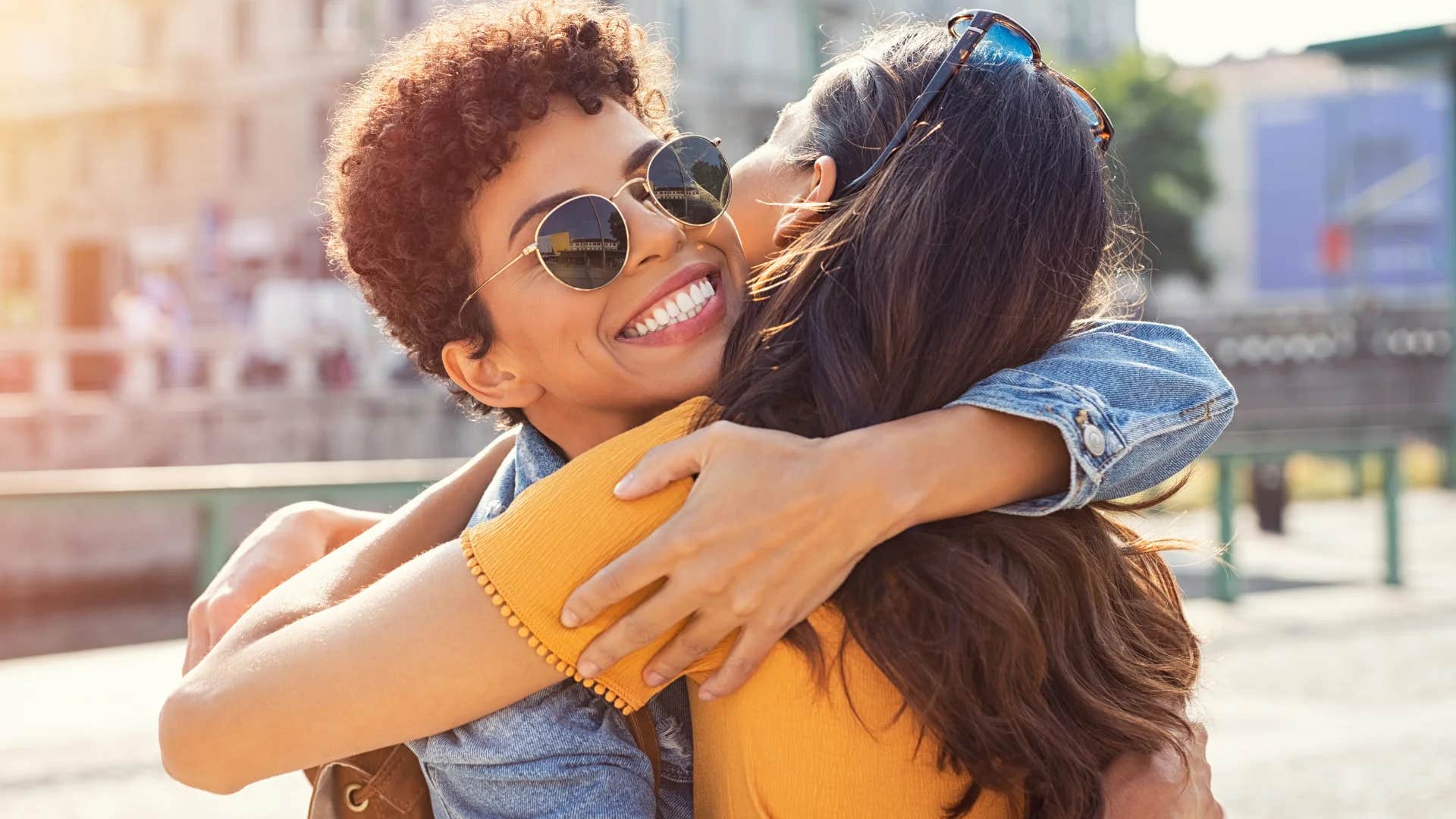 woman hugging friend saying we're not in kansas anymore